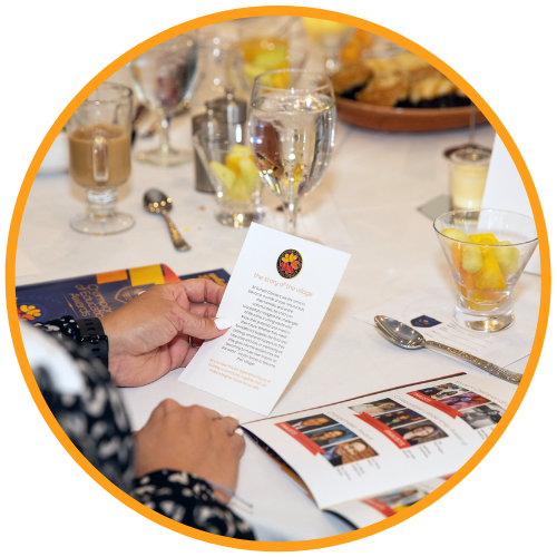 Attendee reads a quote of impact at the banquet table during the School Connect Champions of Education Awards.