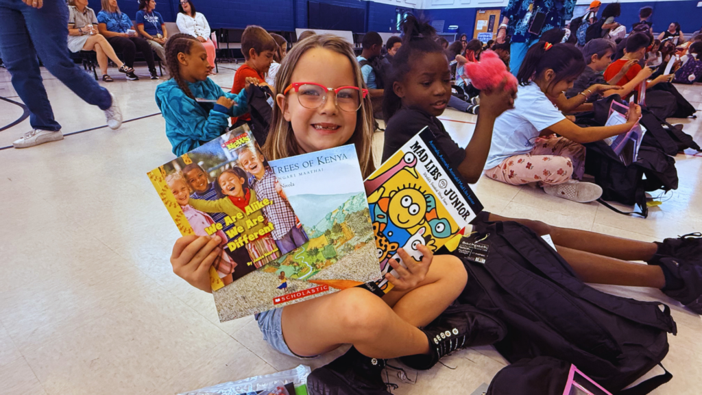 Student shows the reading supplies in her summer backpacs from Thrivent