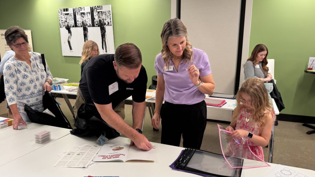 Thrivent Financial employees pack backpacks with reading supplies for students at Larkspur Elementary