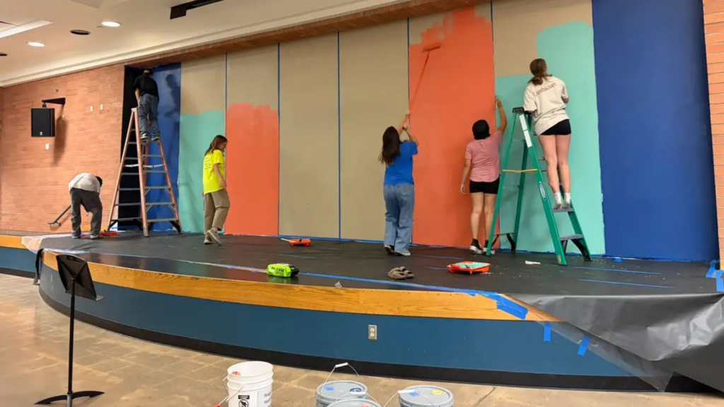 When people hear about Love Our Schools Day, they often picture volunteers showing up with paintbrushes.