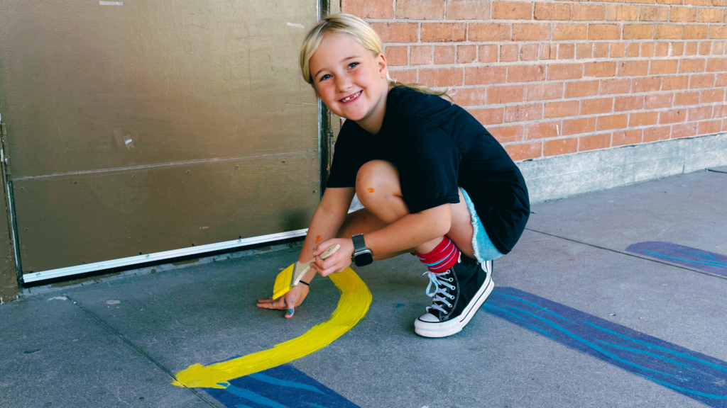 Student paints sensory path for Love Our Schools Day at Litchfield Elementary School